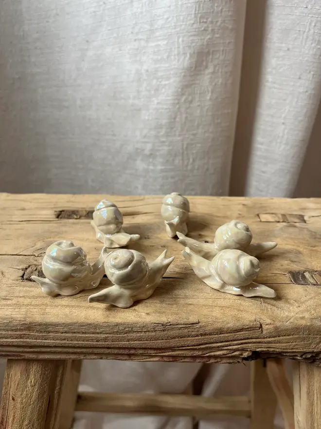ceramic pearl snails on wooden stool
