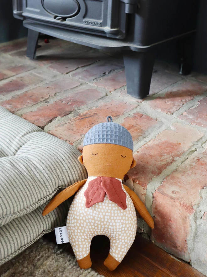 textile acorn doll with brown skin and linen oak leaves