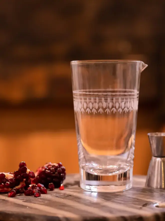 engraved ovals crystal mixing glass. a cocktail glass with an engraved oval pattern.