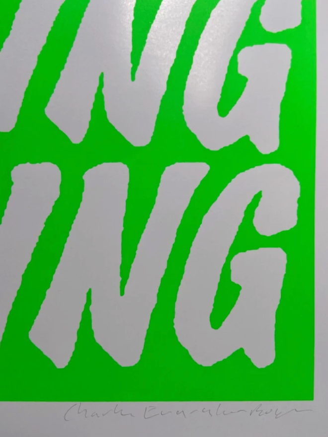 Fluoro Amazing Print. Close up of a print with a vibrant green background, with AMAZING written five times.