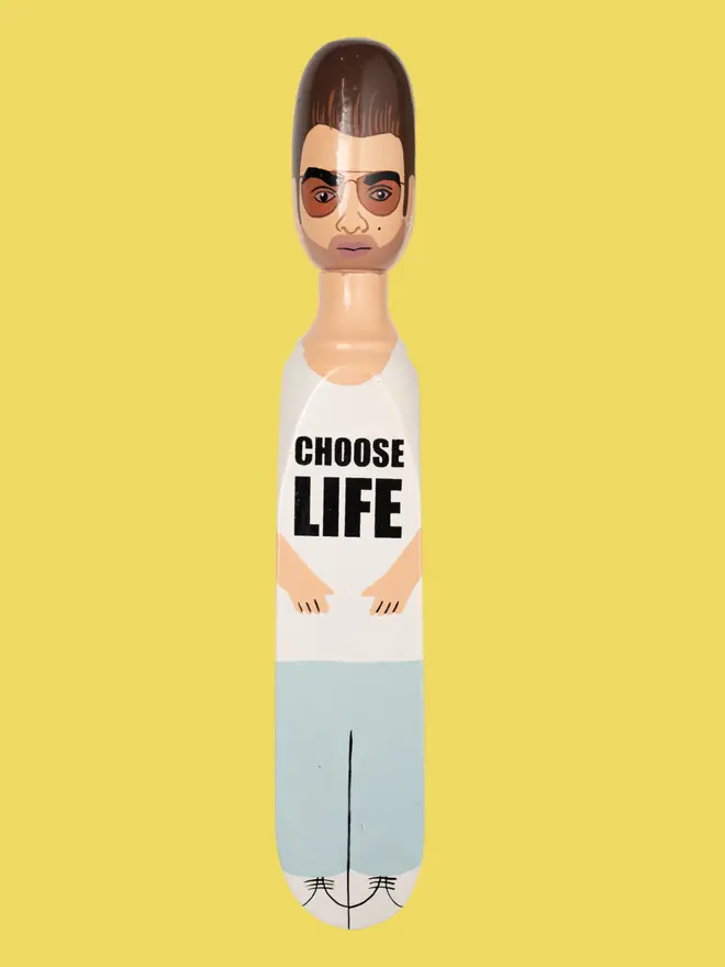 Wooden Door Stopper (Georg Choose Life Outfit), a colourful wooden door stop sitting on a white surface