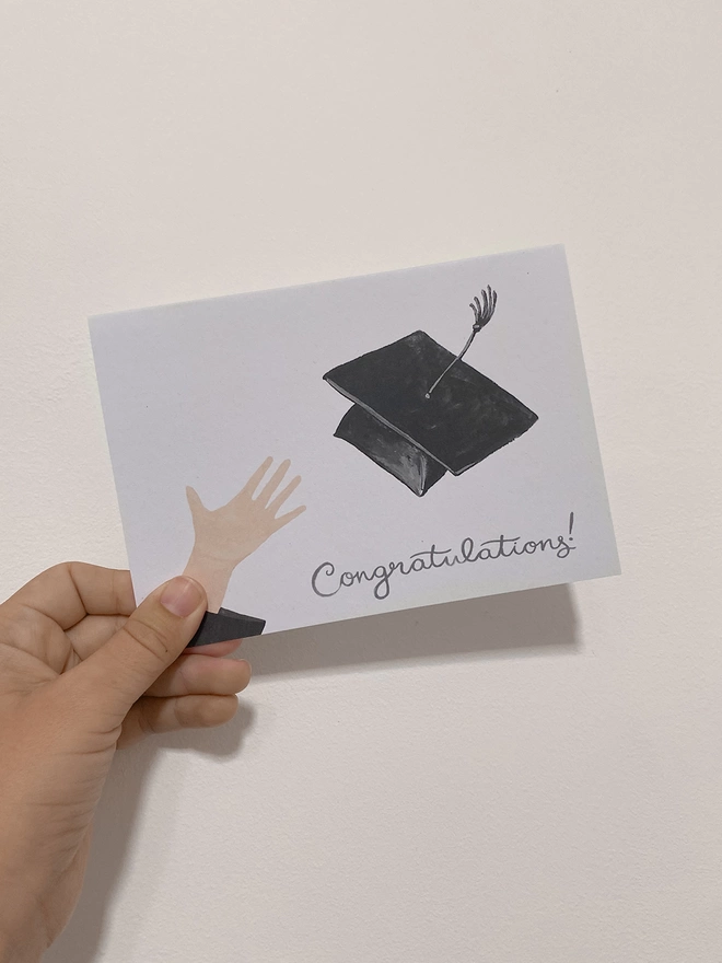 Graduation cap card image in hand