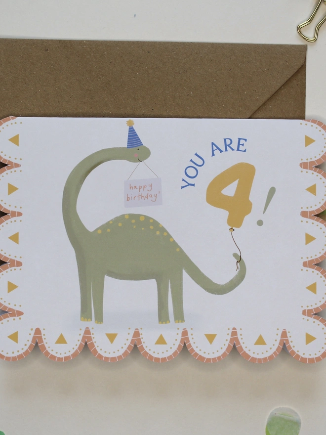 illustrated dinosaur 4th birthday card. scallop edged card 