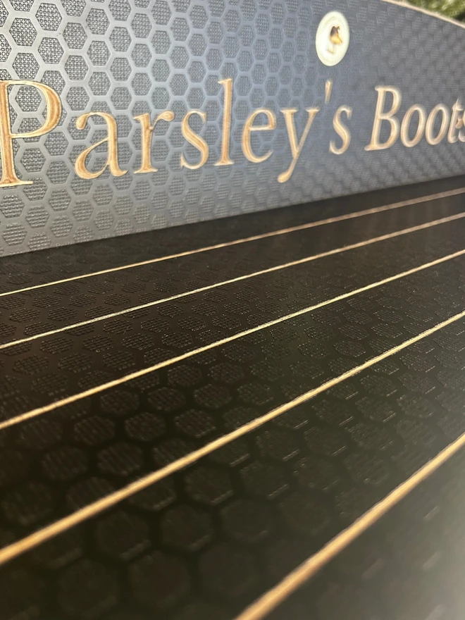 textured of the material and engraving of a wall mounted welly boot rack