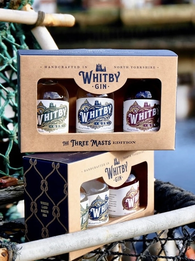 Whitby Distillery Three Masts Gift Box (Set Of 3), a pair of gift boxes sitting on mesh. 