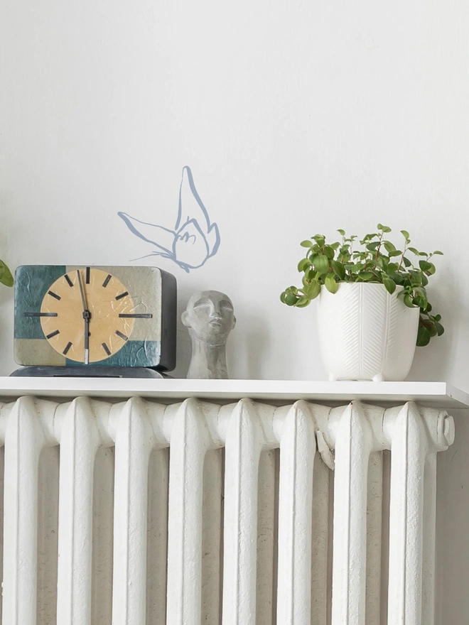 blue butterfly wall sticker sitting above a picture