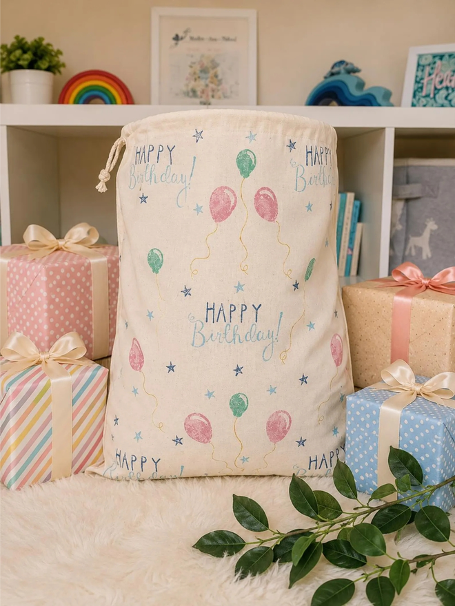 personalised drawstring birthday bag. a drawstring bag with printed balloons and a birthday message.