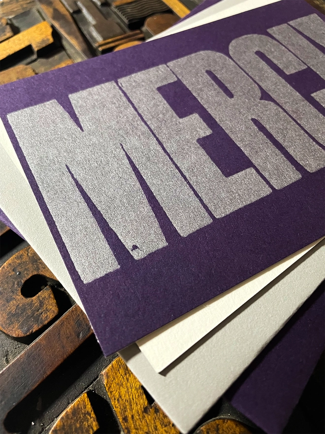 Merci! A beautiful typographic letterpress postcard printed with metallic silver inks printed on rich thick  colourful card with a luxury matching envelope; ideal to send a thank you note to a friend or loved one.