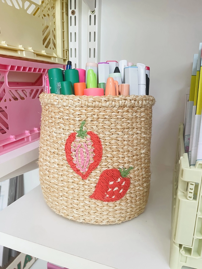 strawberry motif basket displayed on a shelf
