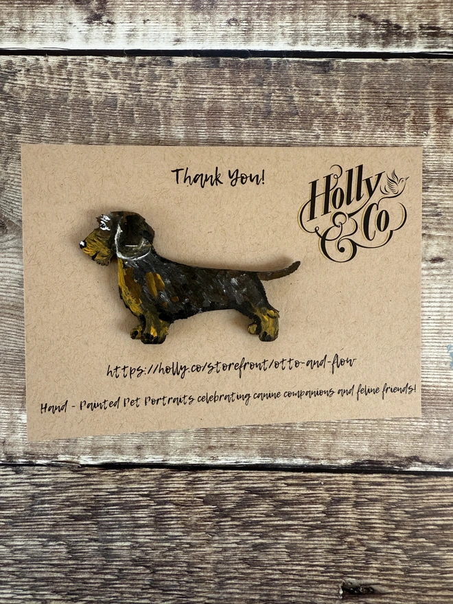 Wire Haired Dachshund wooden hand -painted pin on a postcard background