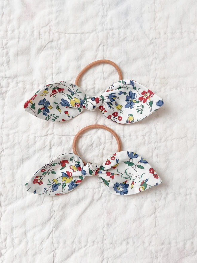 two hair bobbles on a vintage rabbit plate