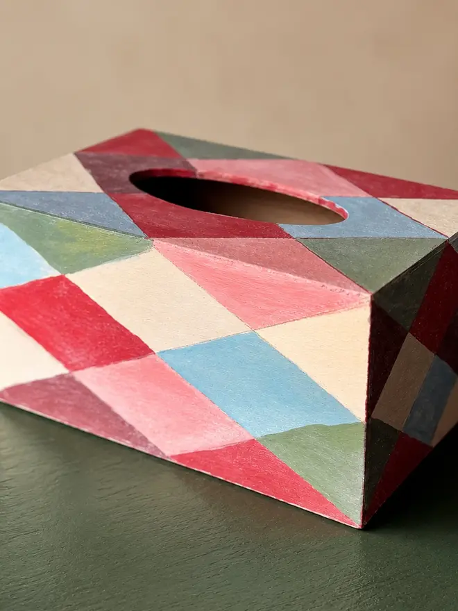 hand-painted harlequin tissue box. a tissue box in multicoloured painted harlequin pattern.