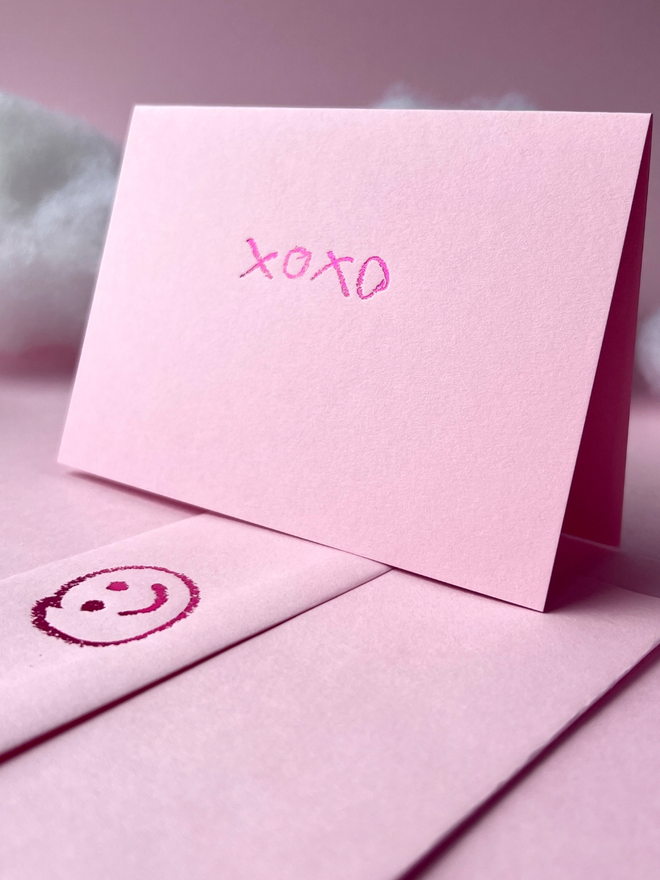 candy pink coloured card with xoxo hand foiled in kids hand writing