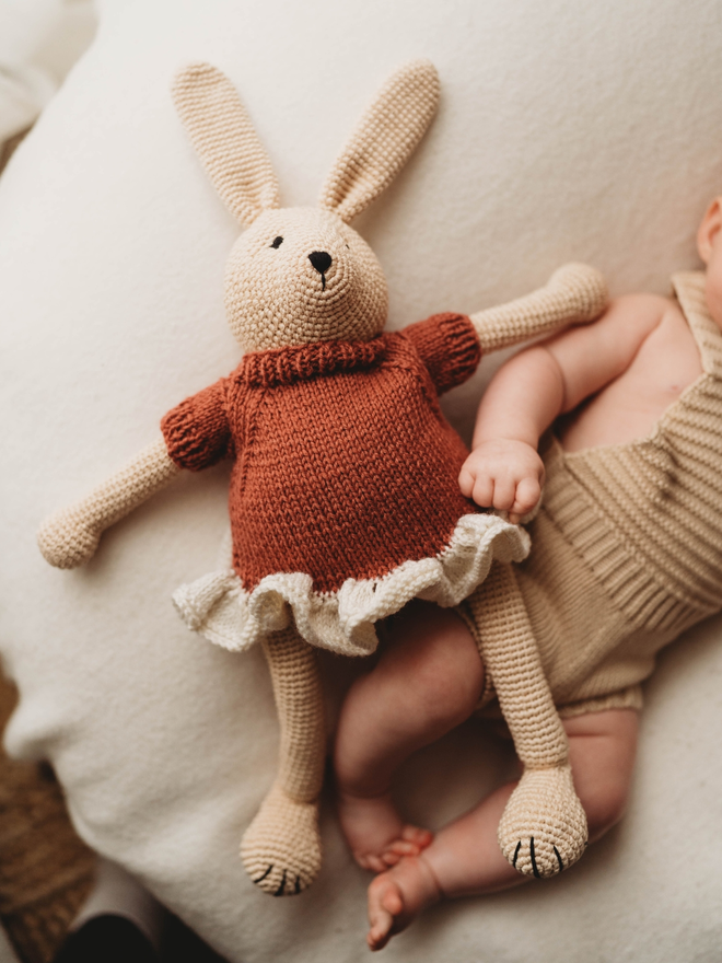 hand crochet bunny rabbit with red and white hand knit dress lifestyle shot