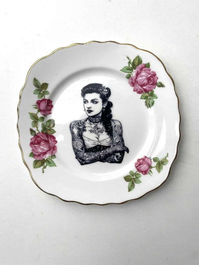 a vintage plate with ornate border, within the centre i have printed the vintage style image of a victorian tattooed sailor woman