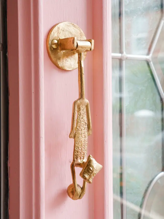 leopard door knocker on a pink door