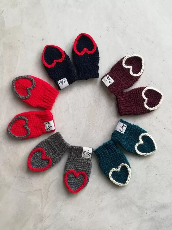 EKA Heart Tipped Mittens seen in a circle.
