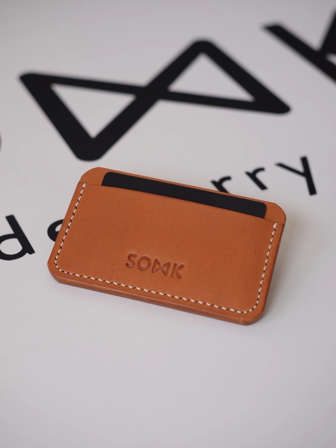 SOWK tan leather card holder seen from the front.