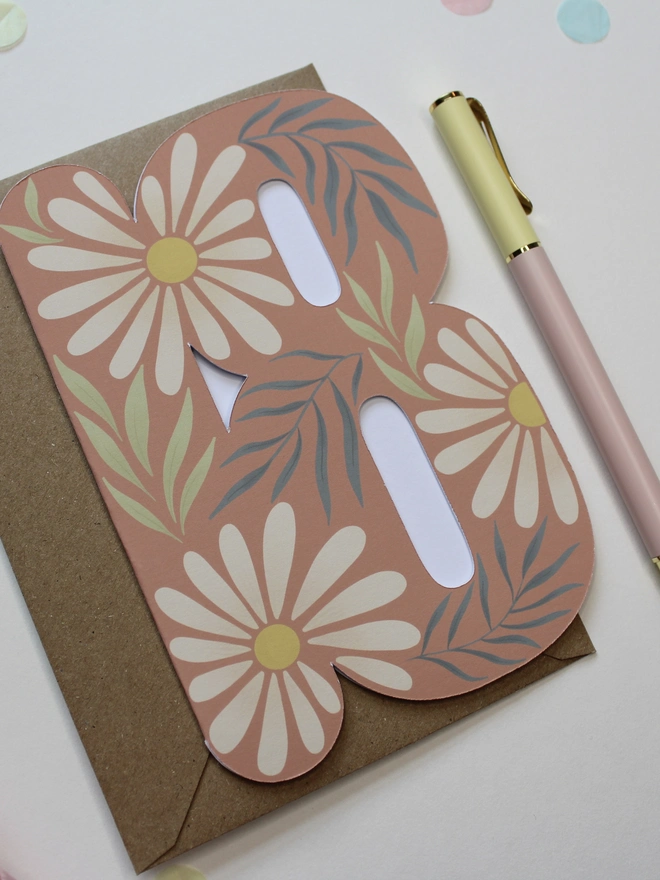 floral 18th birthday card. card shaped like number 18 with daisies and leaves.