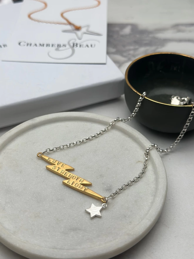 sterling silver chain with personalised gold electric bolt charm and small silver star