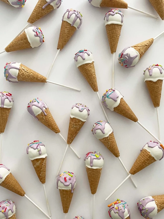 Ice Cream Cake Pops (Pack Of 6, 12, 18, 24), ice cream cake pops placed on a plain surface in a group. 