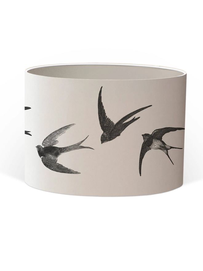 Handmade lampshade featuring graceful flying swallows swooping through a nature-inspired design, adding an elegant touch to any room.