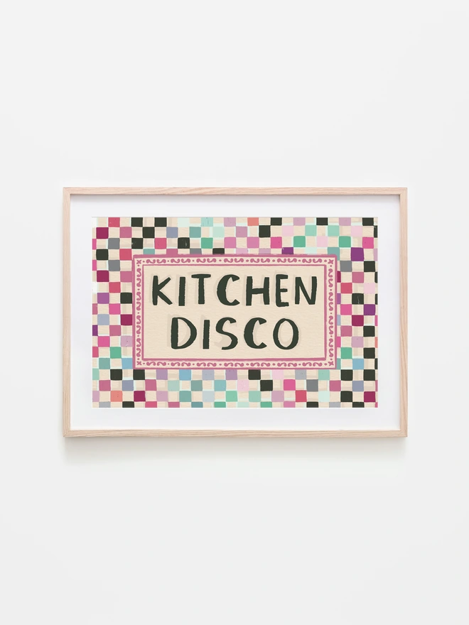 checkerboard pattern print in disco ball colours with text ' kitchen disco' written in the centre