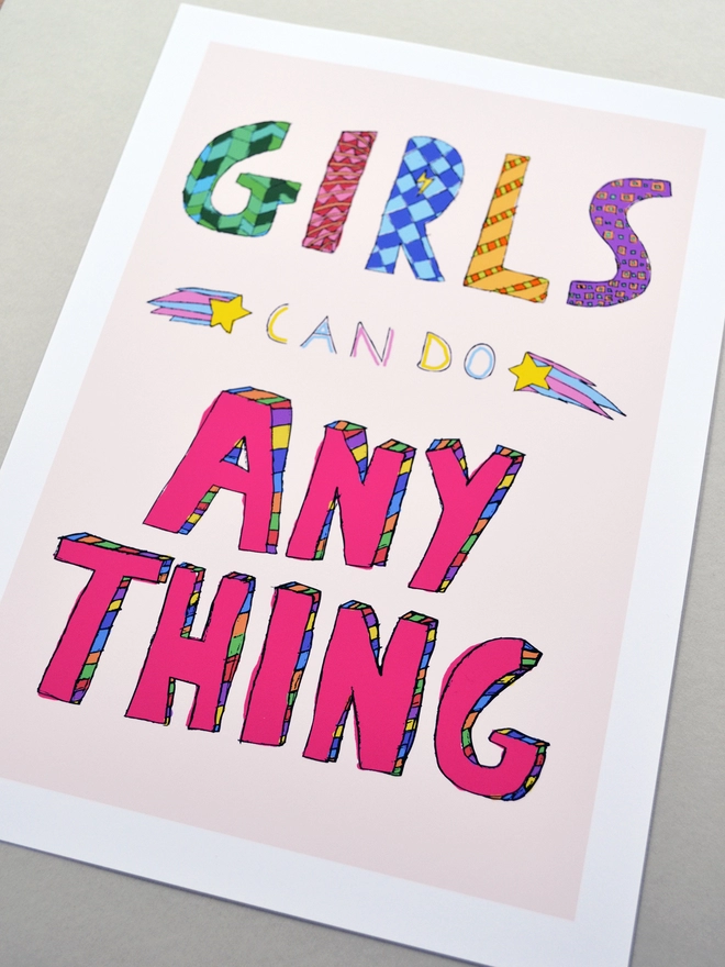 Close up of an art print saying 'Girls can do anything'