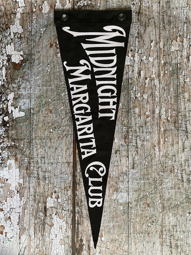Black flag white writting Midnight Margarita Club Practical Magic
