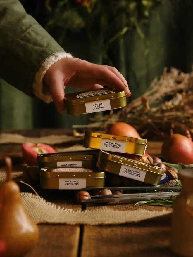 Big Ole Festive Bundle (Pack Of 7), grouped together on a Christmas table, with Christmas food