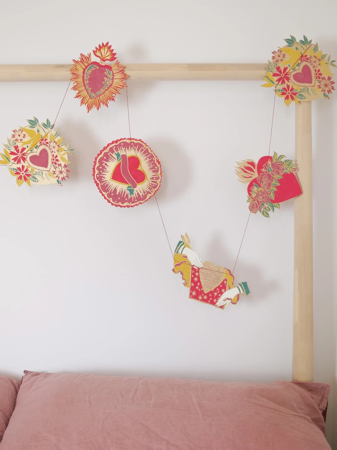 Full shot of image of garland hanging over bed frame