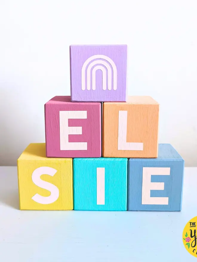 personalised hand-painted name blocks. the name 'elsie' spelt in different coloured square blocks.