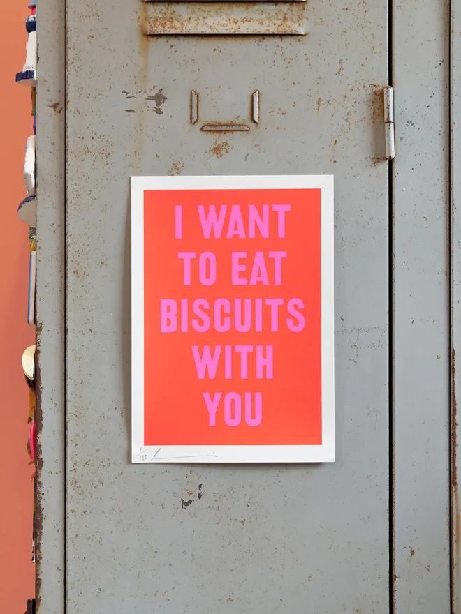 'I Want to Eat Biscuits with You' screen print in red with neon pink text, on a grey locker type background with a slither of coral wall