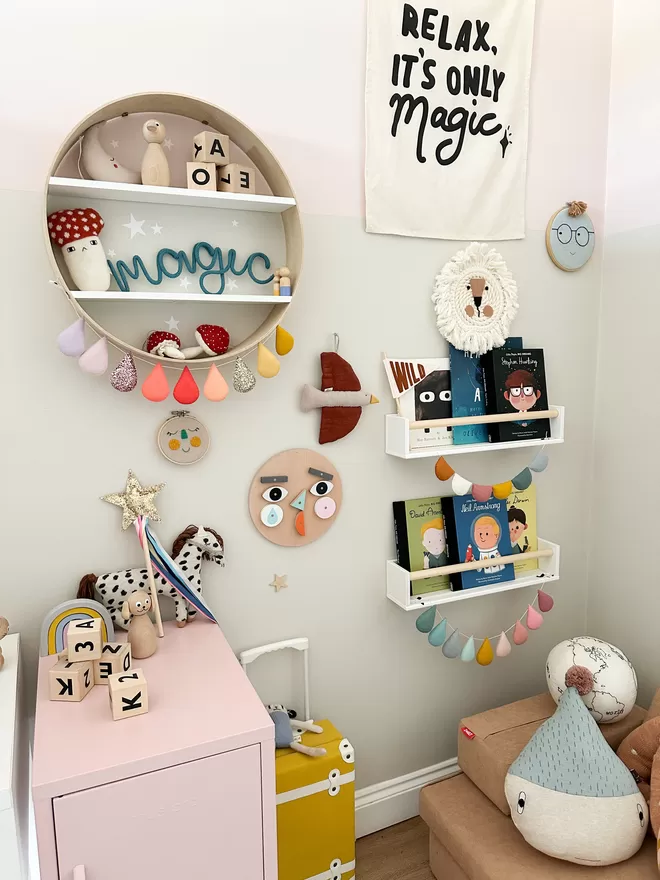 'magic' sign playful nursery decor for the wall propped on a shelf. 