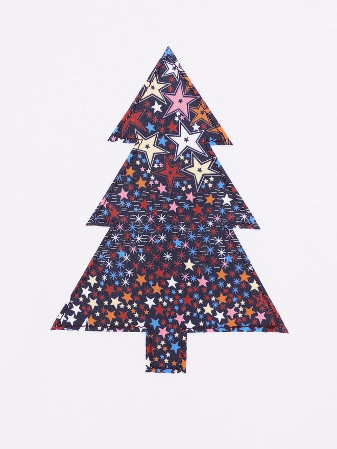 a christmas tree liberty starry print white bodysuit, a close up of the appliqué stitching 