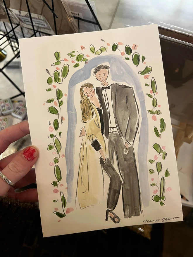 A hand-painted A5-sized personalised portrait of two people by Eleanor Joanna, illustrated in a whimsical style. The background is fully customisable to reflect the buyer's preferences, making it a unique and tailored piece of art.