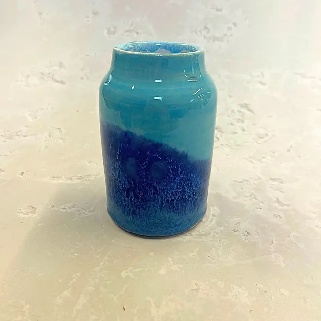 Landscape Medium Vase, a colourful vase sitting on a stone surface. 