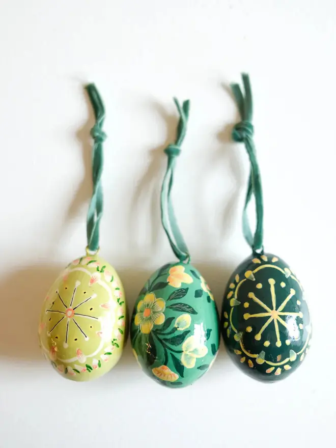 Group shot of hand painted decorative eggs with velvet string