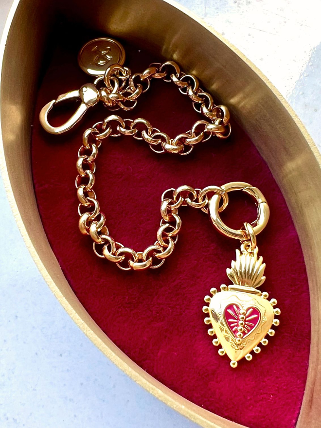 Frida Kahlo scared heart charm on gold belcher chain bracelet inside red velvet jewellery box