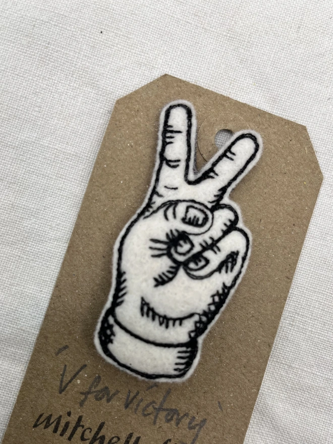 V for victory brooch