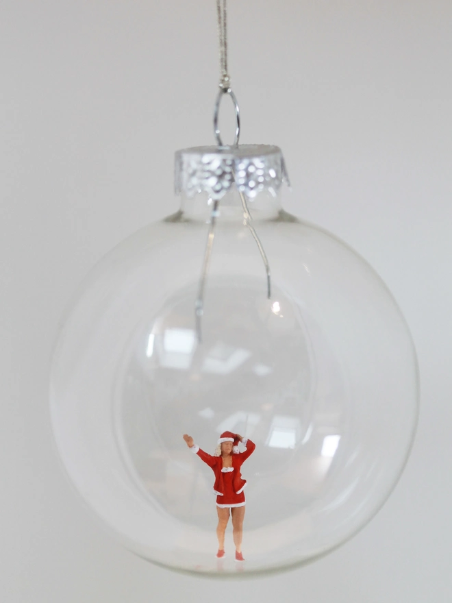 Miniature figure of female santa in a glass Christmas bauble