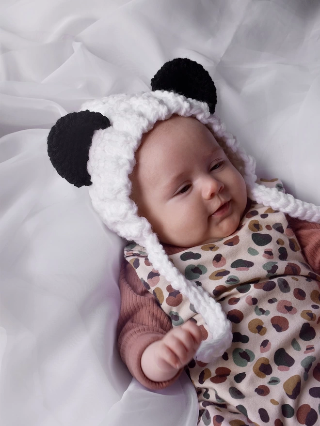 White Panda earred bonnet being worn by a baby
