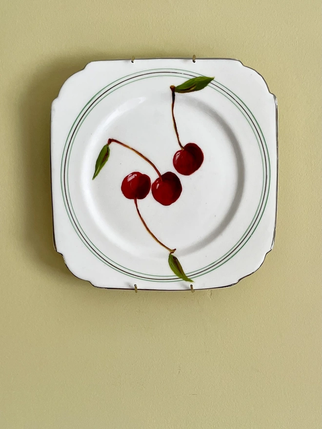 red cherry painting on 1920s plate