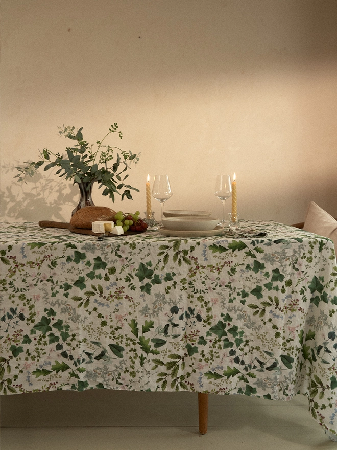 Table laid with linen printed with leaves and flowers