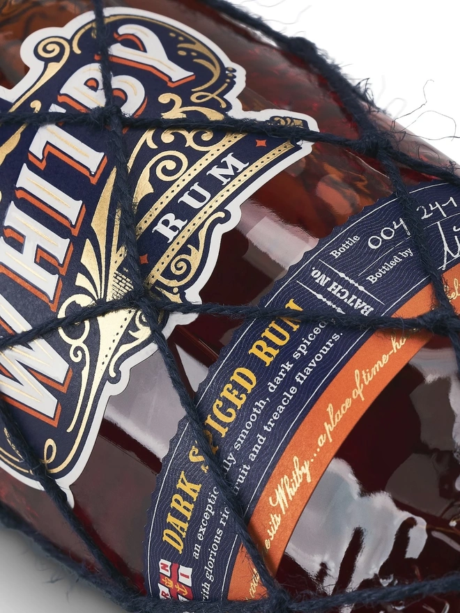 Whitby Dark Spiced Rum - RNLI Edition, a bottle of rum sitting on a plain white surface. 