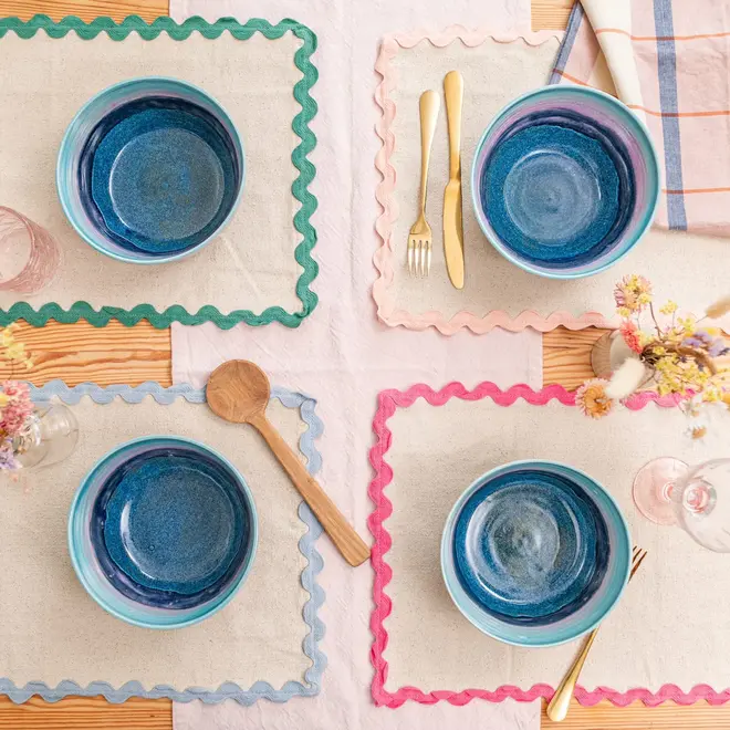 Landscape Ramen Bowl, a colourful table decorated with bowls, utensils and napkins. 