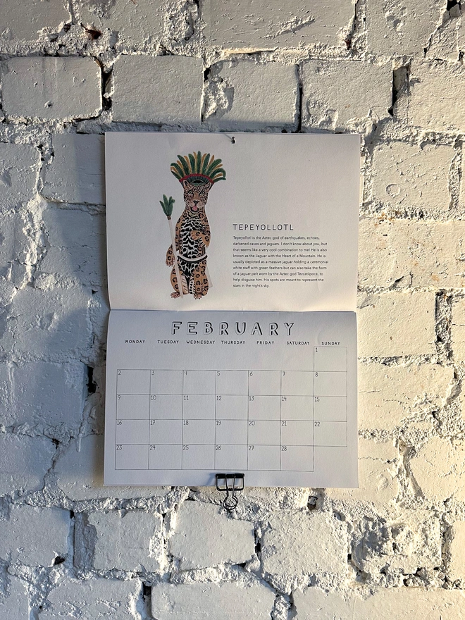 Calendar open to February featuring illustration of Jaguar god