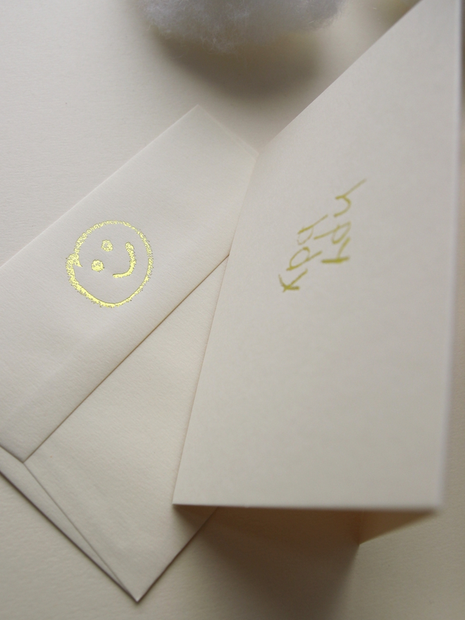 sandy coloured card with hpy bdy hand foiled in kids hand writing