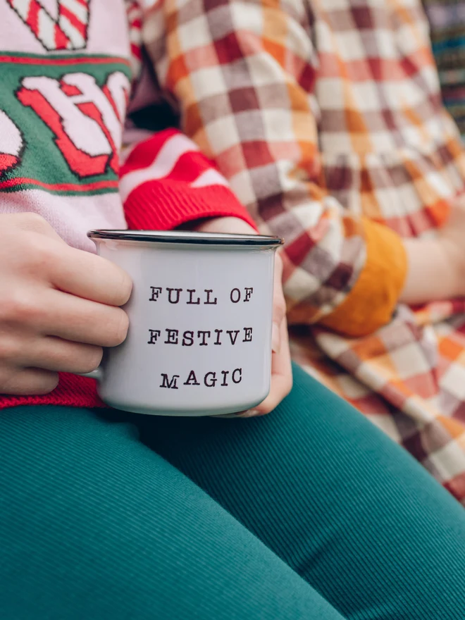 child holding christmas ceramic mug