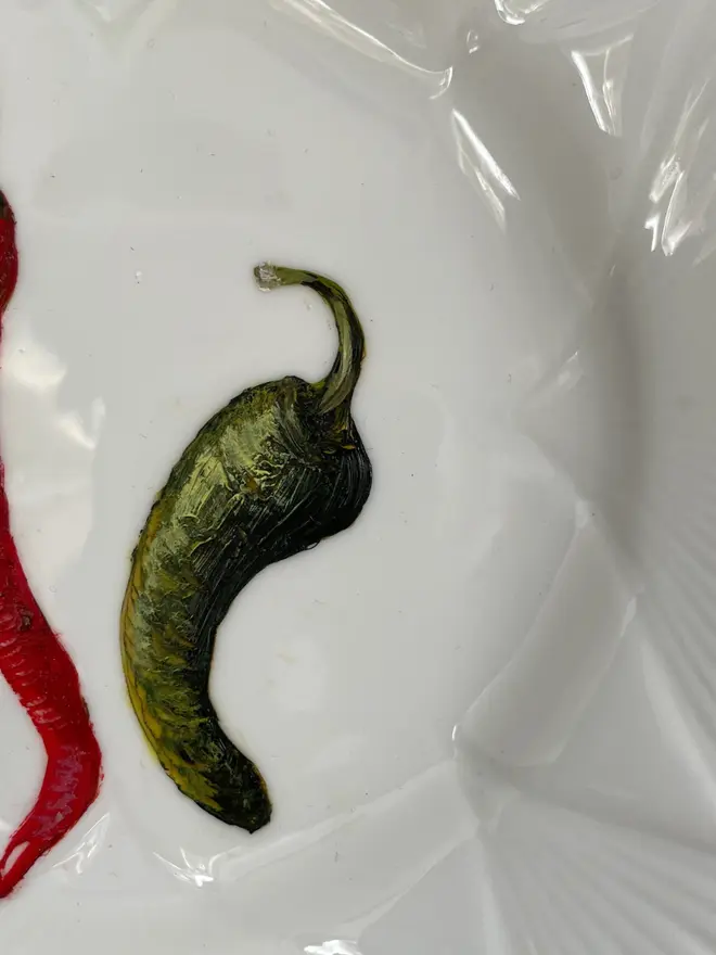 Zoom-in on the Oil Painted Two Chilli On A Tea Plate. 